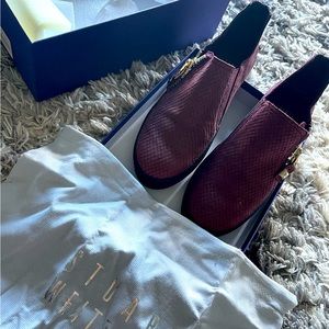 Stuart Weitzman burgundy leather slip on sneakers with gold zipper.